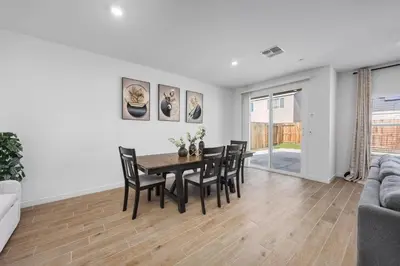 a living room with a dining room table and chairs at Serenity House- Newly Built, Peaceful Stay in Bakersfield