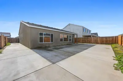 an empty driveway in front of a house at Serenity House- Newly Built, Peaceful Stay in Bakersfield