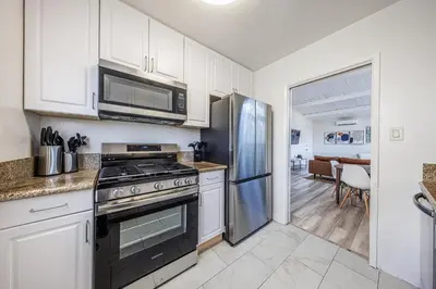 a kitchen with a stove and a refrigerator at Spacious 2-Bedroom Duplex in Beverly Hills Residential Area in Los Angeles