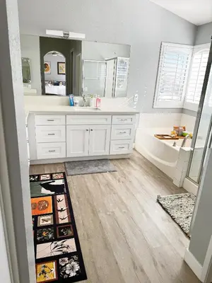 a bathroom with a tub and a sink and a mirror at 3000sqft Modern Minimal 5BR3BA Home Near ONT in Ontario