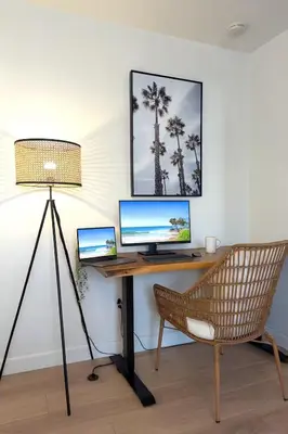 a desk with a computer and a lamp and a chair at Walk 2min to BEACH! Boho 3-Bedroom BEACH Pad with AC, Patio, Laundry & Mid Size Parking in Long Beach