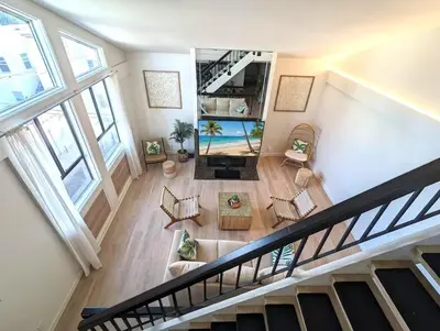 an overhead view of a living room with a staircase at Walk 2min to BEACH! Boho 3-Bedroom BEACH Pad with AC, Patio, Laundry & Mid Size Parking in Long Beach