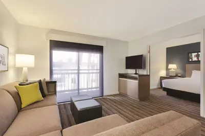 a hotel room with a couch and a bed at Hyatt House Cypress / Anaheim in Cypress