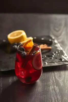 a red drink with orange slices on a table at Hyatt House Cypress / Anaheim in Cypress