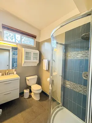 a bathroom with a shower and a toilet and a sink at Charming 4-Bedroom Home Near Bel Air - BG - WW in Los Angeles