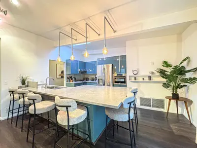 a kitchen with a large island with bar stools at Charming 4-Bedroom Home Near Bel Air - BG - WW in Los Angeles