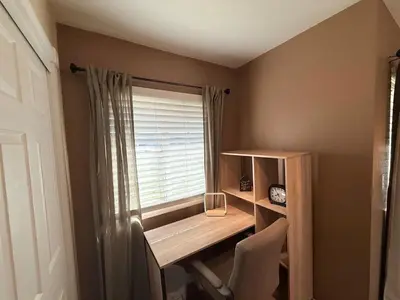 a room with a desk and a window with a chair at Desert Ranch Retreat in Lancaster