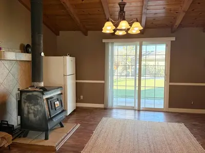 a living room with a stove and a refrigerator at Desert Ranch Retreat in Lancaster