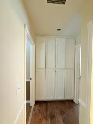 an empty room with white walls and wood floors at Desert Ranch Retreat in Lancaster