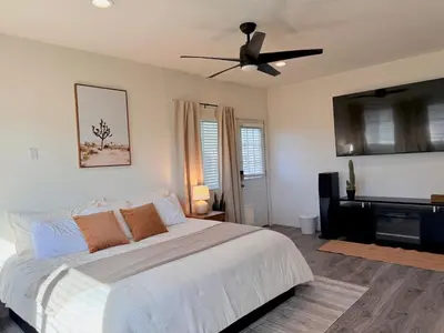 a bedroom with a bed and a ceiling fan at Desert Ranch Retreat in Lancaster