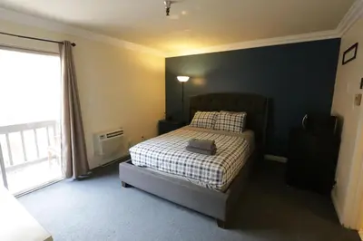 a bedroom with a bed and a large window at Beverly Hills Queen Bed Studio in Los Angeles
