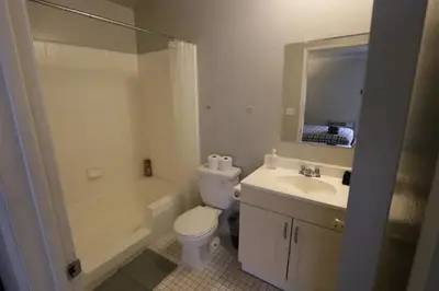 a bathroom with a toilet and a sink and a mirror at Beverly Hills Queen Bed Studio in Los Angeles