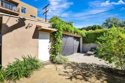 a garage with ivy growing on the side of a house at Charming 2BR 2BA Los Angeles Home with Character in Sherman Oaks Community Hospital Heliport