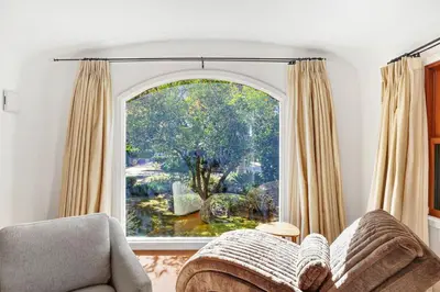 a living room with a large window and a couch at Charming 2BR 2BA Los Angeles Home with Character in Sherman Oaks Community Hospital Heliport