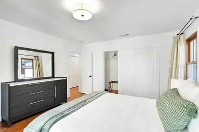a bedroom with a large bed with a dresser and a mirror at Charming 2BR 2BA Los Angeles Home with Character in Sherman Oaks Community Hospital Heliport