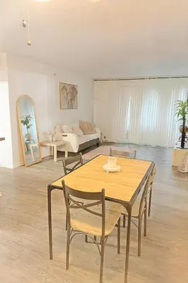 a living room with a table and chairs and a couch at Hollywood Hills Haven - Resort Living Near Universal Studios & Warner Bros in Los Angeles