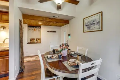 a dining room with a wooden table and white chairs at 5 Mi to Mountain High Resort Home with Gaming Area in Wrightwood