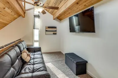 a living room with a couch and a flat screen tv at 5 Mi to Mountain High Resort Home with Gaming Area in Wrightwood