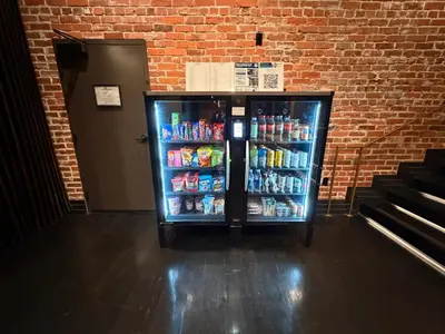a refrigerator with drinks in it in front of a brick wall at Studio Haven in the Heart of Hollywood in Los Angeles