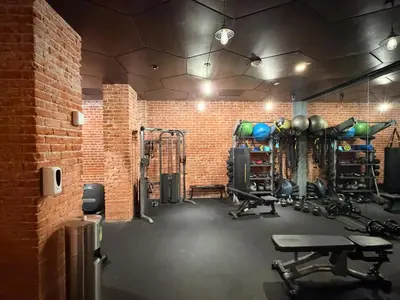 a gym with equipment and a brick wall at Studio Haven in the Heart of Hollywood in Los Angeles