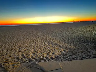a view of the beach at sunset at Beach Sweet condo home in Los Angeles