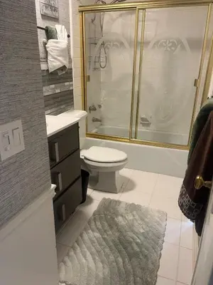 a bathroom with a shower and a toilet and a sink at Beach Sweet condo home in Los Angeles