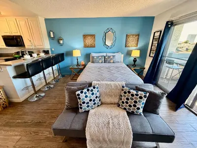 a blue bedroom with a bed and a couch at Hollywood Studio with Pool, Parking, Gym & Sign View in Los Angeles