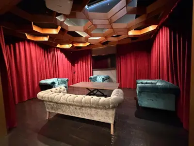 a room with a couch and a table and red curtain at Modern & Popular Hollywood Studio at GW in Los Angeles