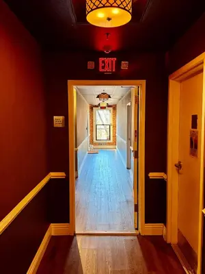 a hallway with an exit sign on the ceiling at Modern & Popular Hollywood Studio at GW in Los Angeles