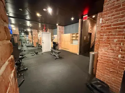 a gym with several chairs and a brick wall at Modern & Popular Hollywood Studio at GW in Los Angeles