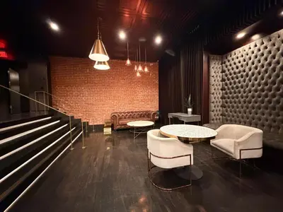 a room with two tables and chairs and a brick wall at Modern & Popular Hollywood Studio at GW in Los Angeles