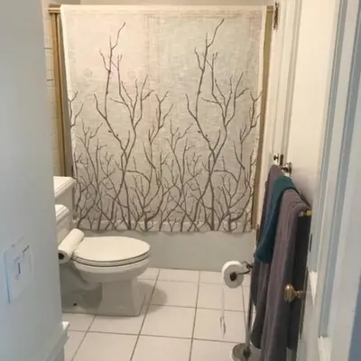 a bathroom with a shower curtain with a toilet at Sweet Beautiful 2 bedrooms home in Los Angeles