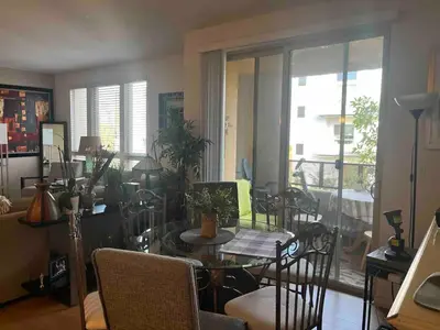 a dining room with a glass table and chairs at Sweet Beautiful 2 bedrooms home in Los Angeles