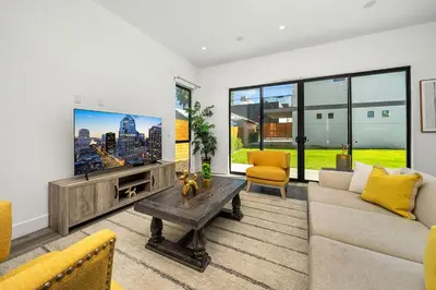 a living room with a couch and a tv at 5BR Gorgeous Melrose Villa with Parking in Los Angeles