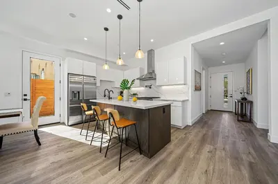 a kitchen and dining room with a island and chairs at 5BR Gorgeous Melrose Villa with Parking in Los Angeles