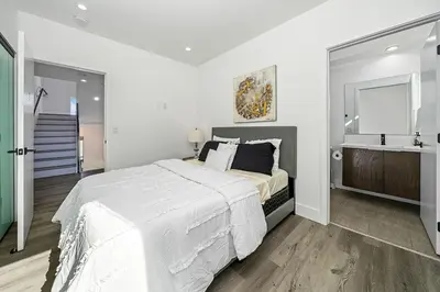 a white bedroom with a large bed and a sink at 5BR Gorgeous Melrose Villa with Parking in Los Angeles