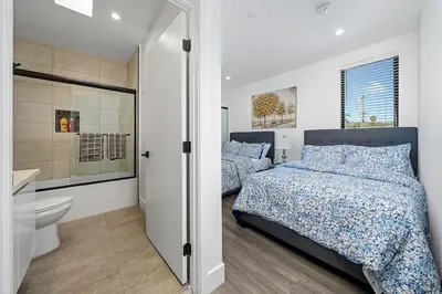 a bedroom with two beds and a toilet and a bathroom at 5BR Gorgeous Melrose Villa with Parking in Los Angeles