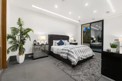 a bedroom with a bed and a potted plant at Ultra Luxury 5BR Beverly Hills Estate with Private Pool Spa and Canyon Views in Los Angeles