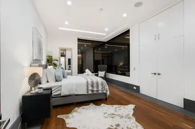 a bedroom with a bed and a living room at Ultra Luxury 5BR Beverly Hills Estate with Private Pool Spa and Canyon Views in Los Angeles