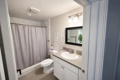 a bathroom with a sink and a toilet and a mirror at Vernon Homes For The Soul in Los Angeles