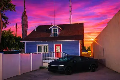 a car parked in front of a house with a sunset at Vernon Homes For The Soul in Los Angeles