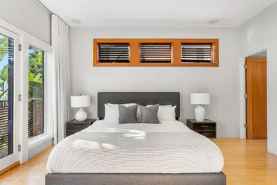 a bedroom with a large bed with two night stands at Vibrant SoCal Venice Beach Retreat in Los Angeles