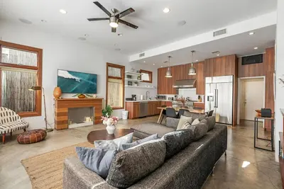 a living room with a couch and a kitchen at Vibrant SoCal Venice Beach Retreat in Los Angeles