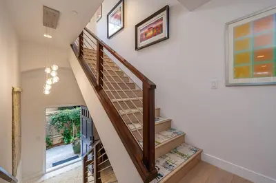 a staircase in a home with a wooden stair case at Phenomenal King, Air, Rooftop Deck, Walk to Beach in Hermosa Beach
