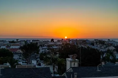 a view of a city at sunset at Phenomenal King, Air, Rooftop Deck, Walk to Beach in Hermosa Beach