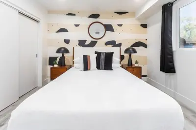 a bedroom with a large white bed and a window at Modern 3BR Retreat with Rooftop Deck Sleeps 8 in Los Angeles