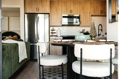 a kitchen with a counter with chairs and a refrigerator at Hollywood Celebrity 2 Bd with SkyLine and Hollywood Sing View in Los Angeles