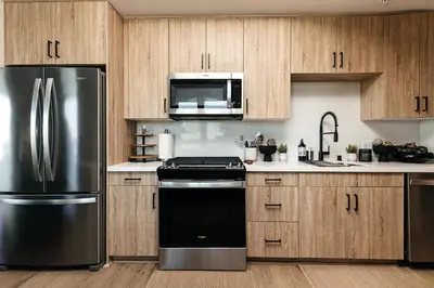 a kitchen with a stainless steel refrigerator and a microwave at Hollywood Celebrity 2 Bd with SkyLine and Hollywood Sing View in Los Angeles