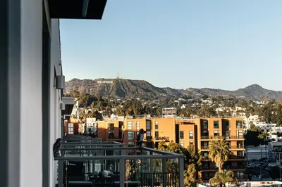 a view of the city from a balcony of a building at Hollywood Celebrity 2 Bd with SkyLine and Hollywood Sing View in Los Angeles