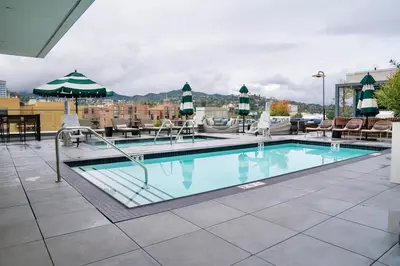 a swimming pool at a hotel with chairs and tables at Hollywood Palladium 1 BD EV charger Free Parking in Los Angeles